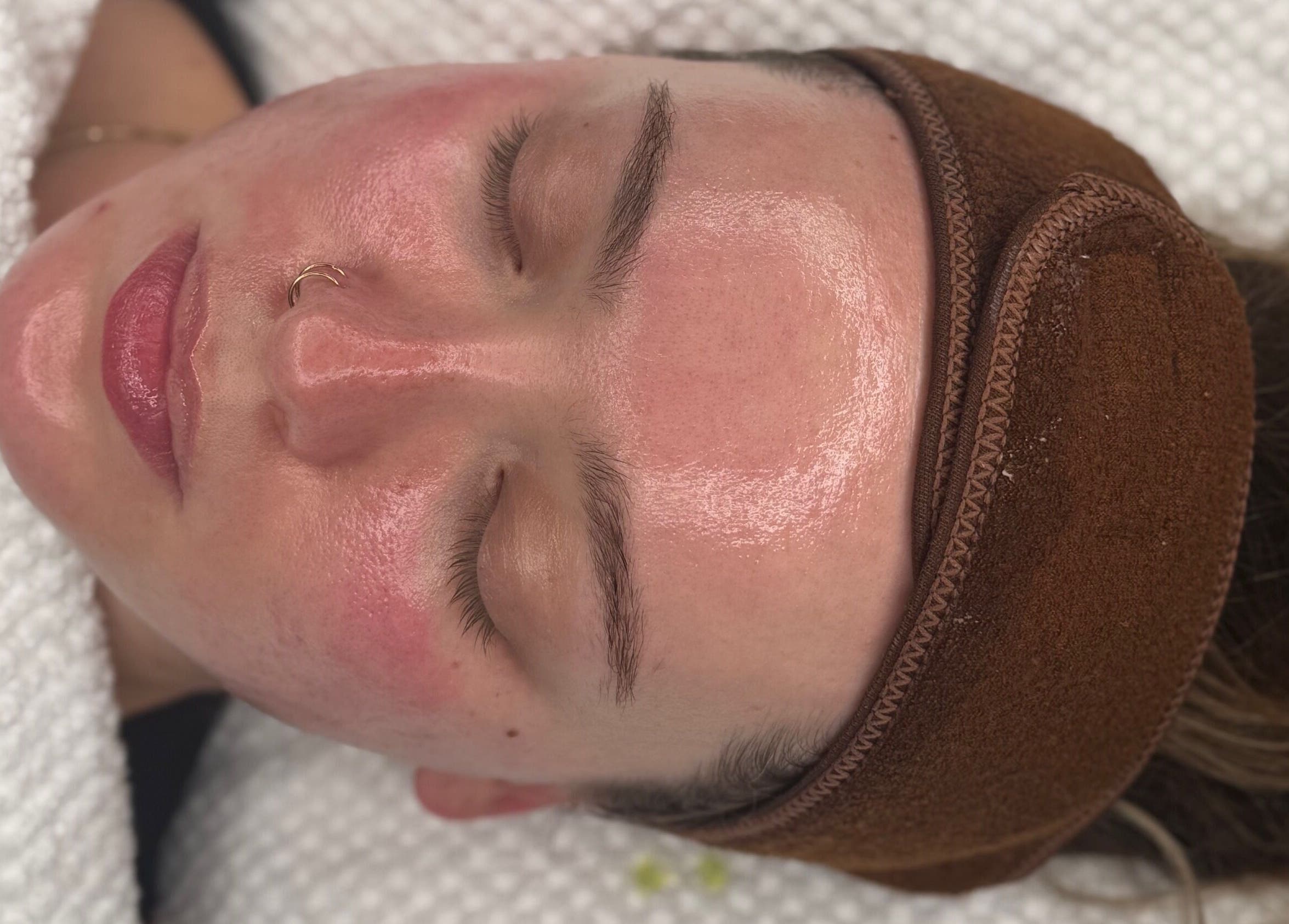 Client receiving facial at HYDRASKIN STUDIO, London, England, showcasing radiant skin treatment.