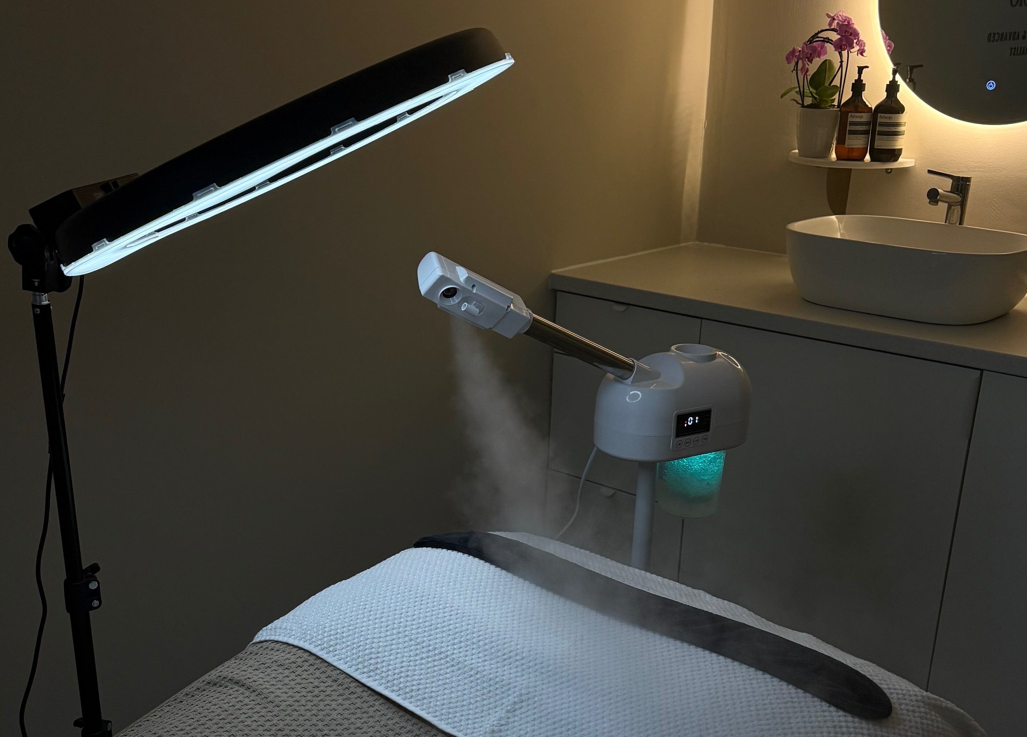 Steaming facial treatment setup at HydraSkin Studio, London, England, GB, with elegant lighting and modern decor.