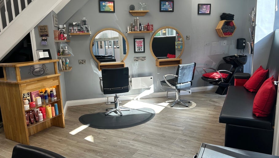 Modern salon interior at Sarah J’s Hair Studio in Pocklington, England, GB, featuring stylish chairs and mirrors.