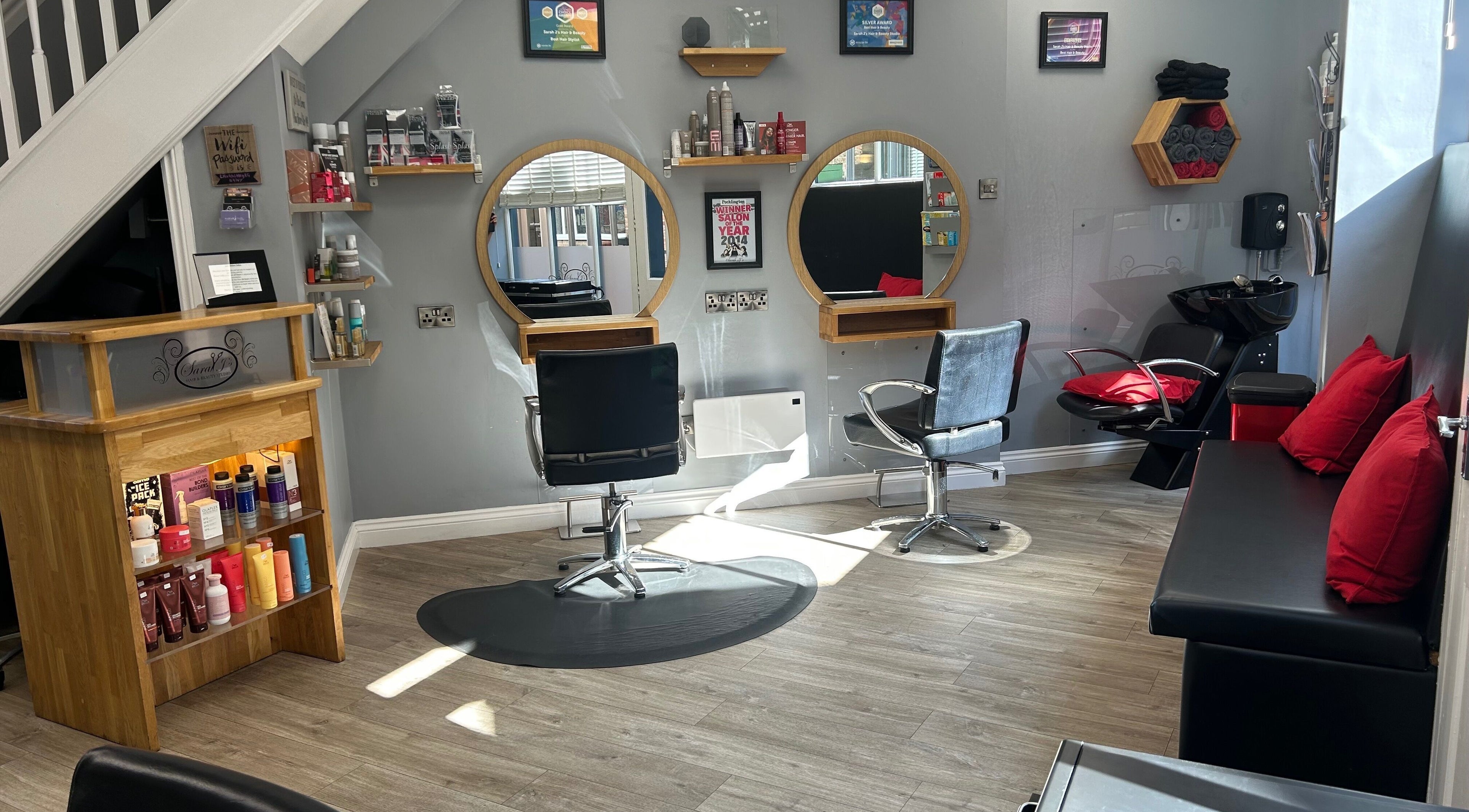 Modern salon interior at Sarah J’s Hair Studio in Pocklington, England, GB, featuring stylish chairs and mirrors.