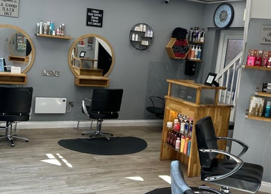 Modern interior of Sarah J’s Hair Studio in Pocklington, England, GB with stylish mirrors and salon chairs.