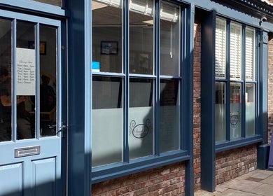 Front view of Sarah J’s Hair Studio in Pocklington, England, showcasing its elegant blue entrance.