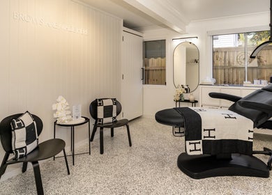 Elegant treatment room at SHÈ - Skin House Eudlo, Eudlo, Queensland, AU. Modern chairs and treatment bed.