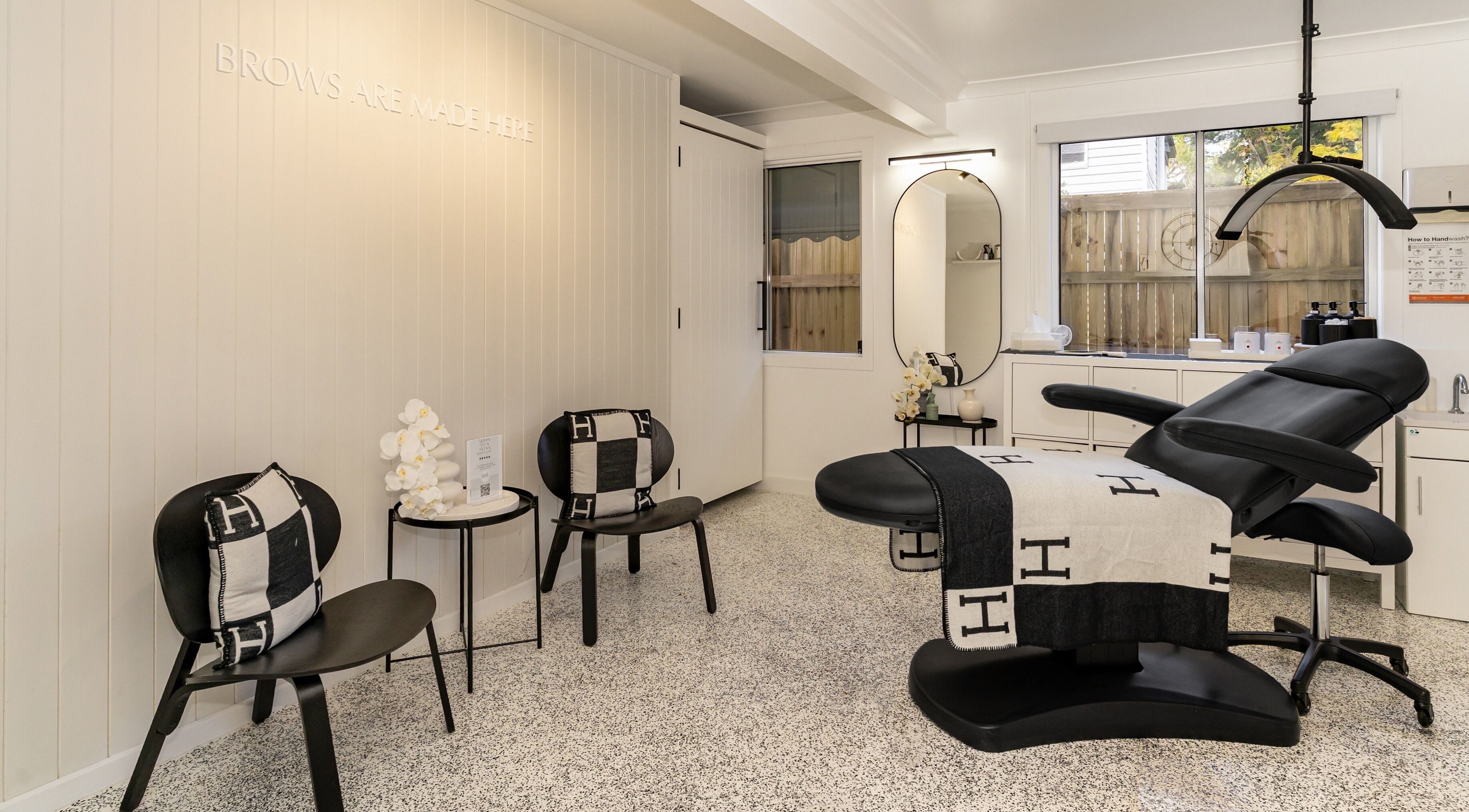 Elegant treatment room at SHÈ - Skin House Eudlo, Eudlo, Queensland, AU. Modern chairs and treatment bed.