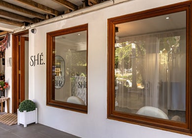Front entrance of SHÈ - Skin House Eudlo in Eudlo, Queensland, AU, showcasing welcoming decor and large windows.