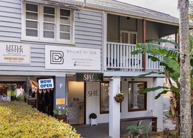 Exterior of SHÈ - Skin House Eudlo, nestled in Eudlo, Queensland, AU, surrounded by lush greenery.