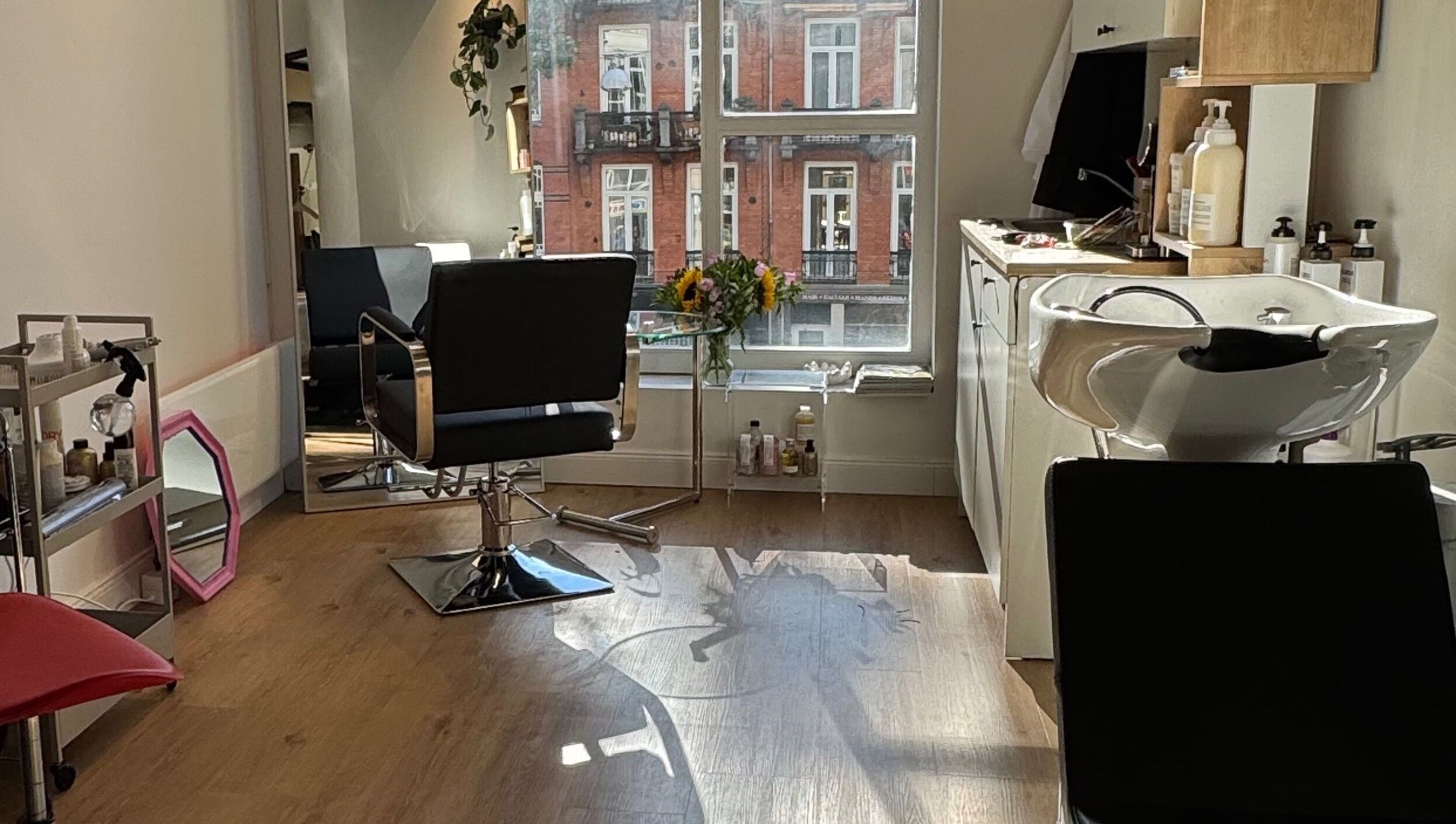 Stylish salon interior at MUSUBI Lab, Amsterdam, Noord-Holland, NL with hairdressing station and vibrant decor.