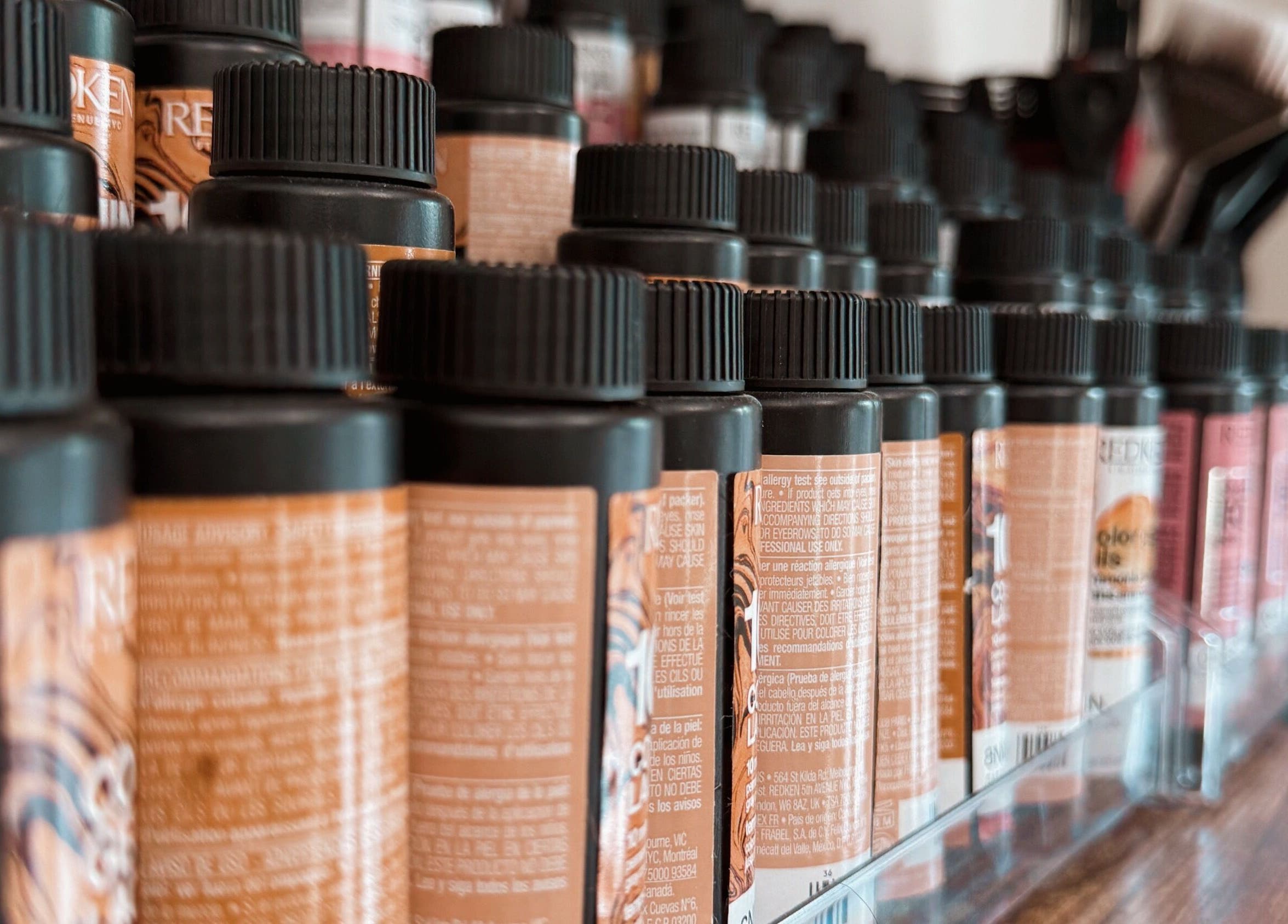 Rows of beauty product bottles at Rhythm & Roots, Ayr, Ontario, CA, showcasing variety and style.