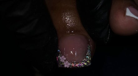 Elegant nail art with pink flowers and glitter from Marissa Halle Nails, San Fernando, Princes Town Regional Corporation, TT.