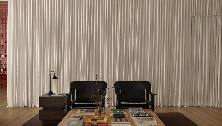Chic waiting area at Studio Julie Lemke with black chairs, table, and white curtains in Dubai, Dubai, AE.