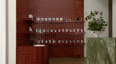 Elegant red tiled product display at Studio Julie Lemke, Dubai, Dubai, AE with lush floral arrangement.