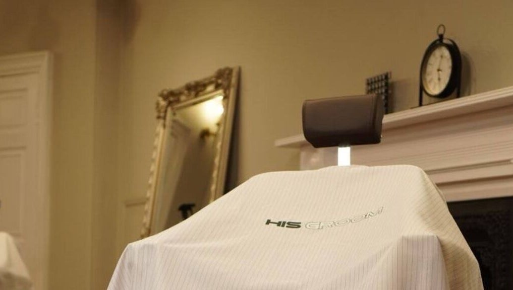 Barber chair at His Grooming in Ayr, Scotland, GB with elegant decor in background.