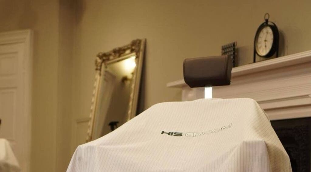 Barber chair at His Grooming in Ayr, Scotland, GB with elegant decor in background.