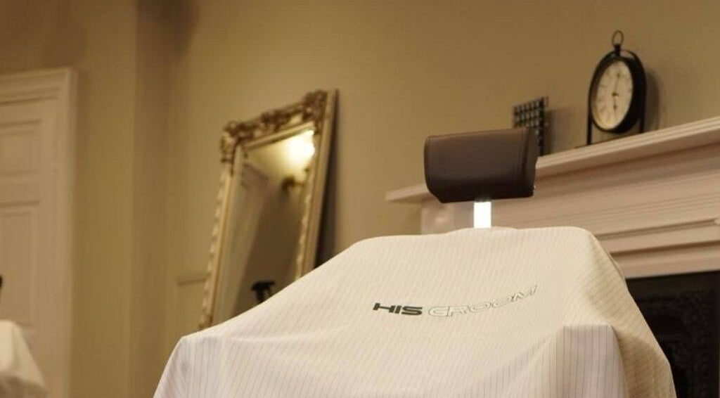 Barber chair at His Grooming in Ayr, Scotland, GB with elegant decor in background.