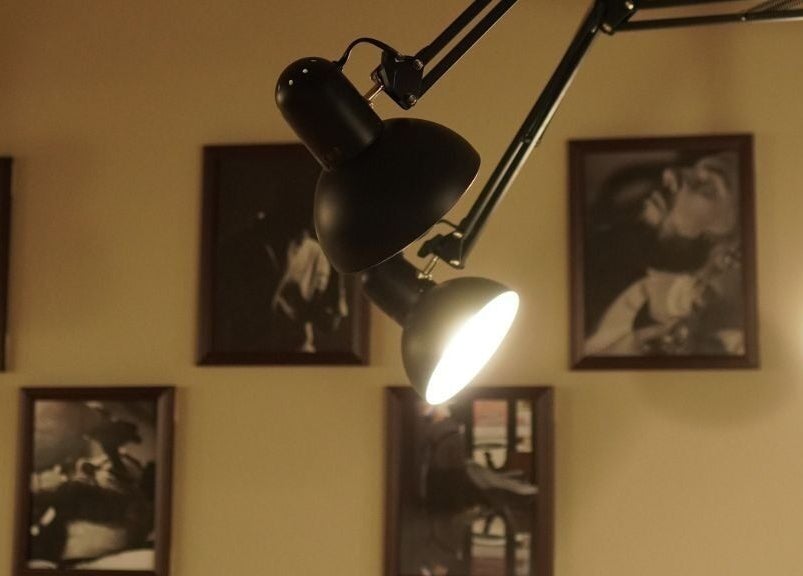 Stylish lighting and framed artwork at His Grooming, Ayr, Scotland, GB, creating a warm and inviting atmosphere.