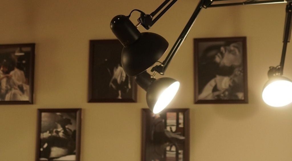 Stylish lighting and framed artwork at His Grooming, Ayr, Scotland, GB, creating a warm and inviting atmosphere.