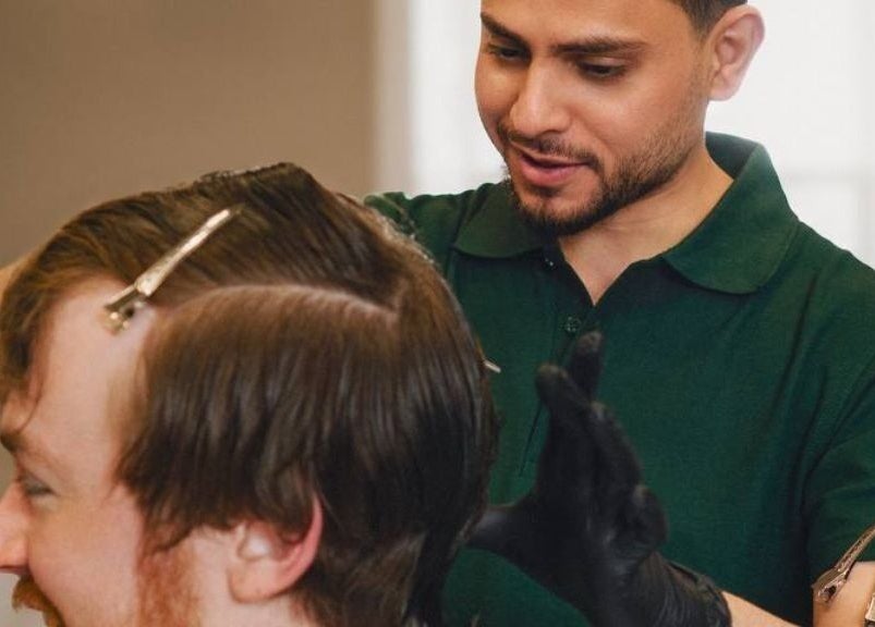 Barber styling hair at His Grooming in Ayr, Scotland, GB. Professional care and precision.