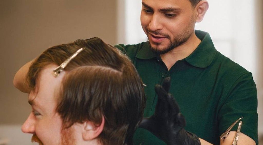 Barber styling hair at His Grooming in Ayr, Scotland, GB. Professional care and precision.