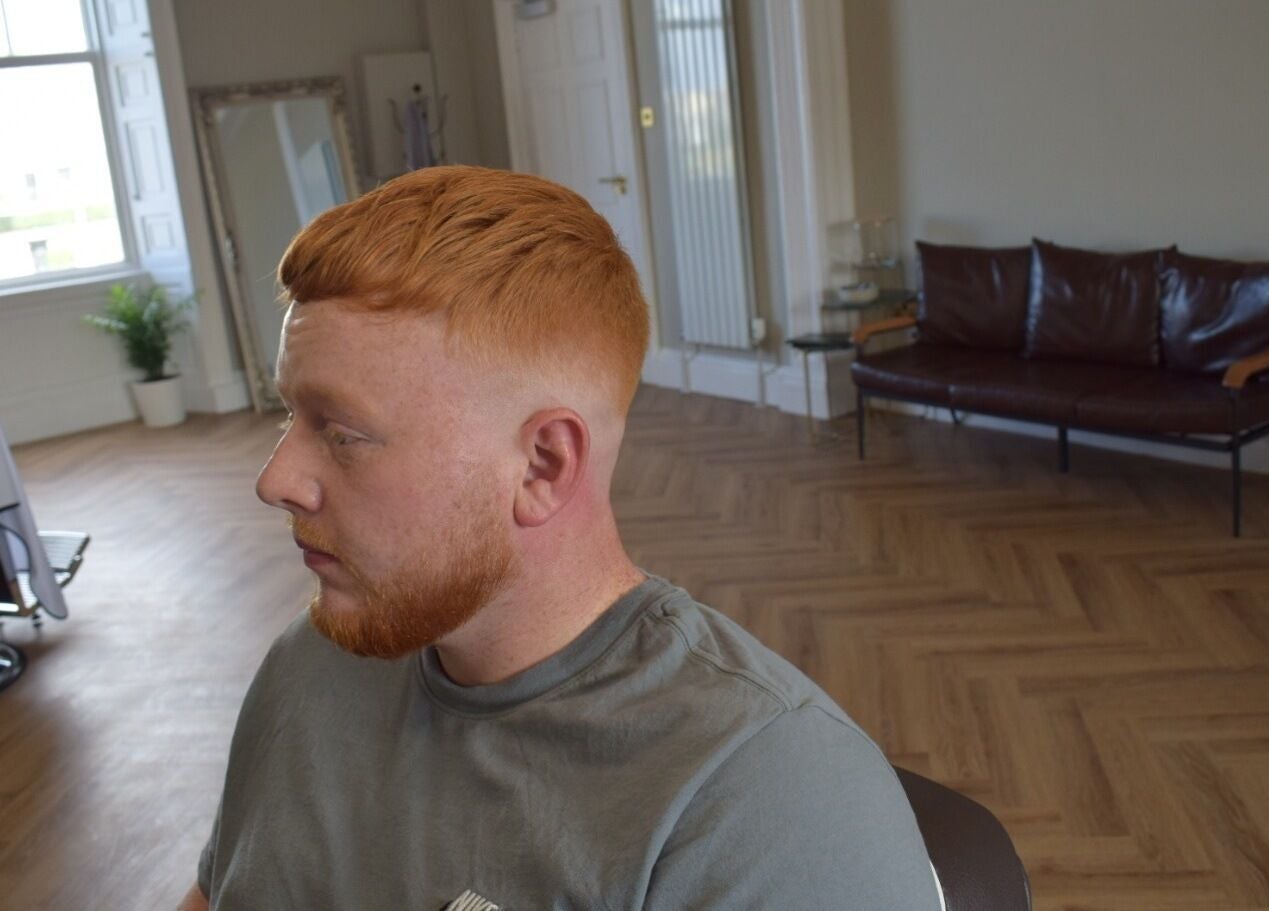 Modern haircut at His Grooming in Ayr, Scotland, GB, showcasing stylish interior and comfortable seating.