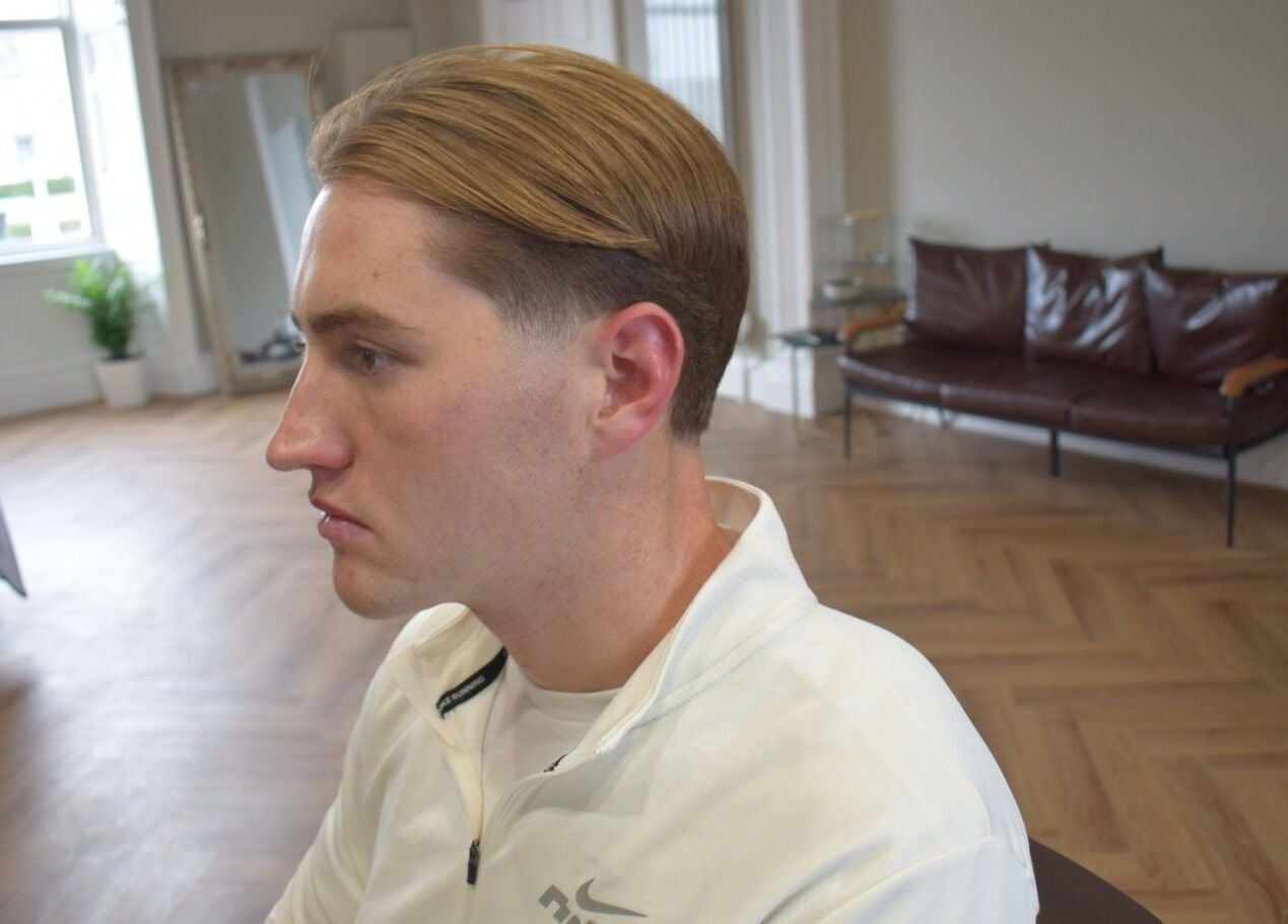 A client at His Grooming in Ayr, Scotland, GB, showcasing a stylish hairstyle in a modern salon interior.
