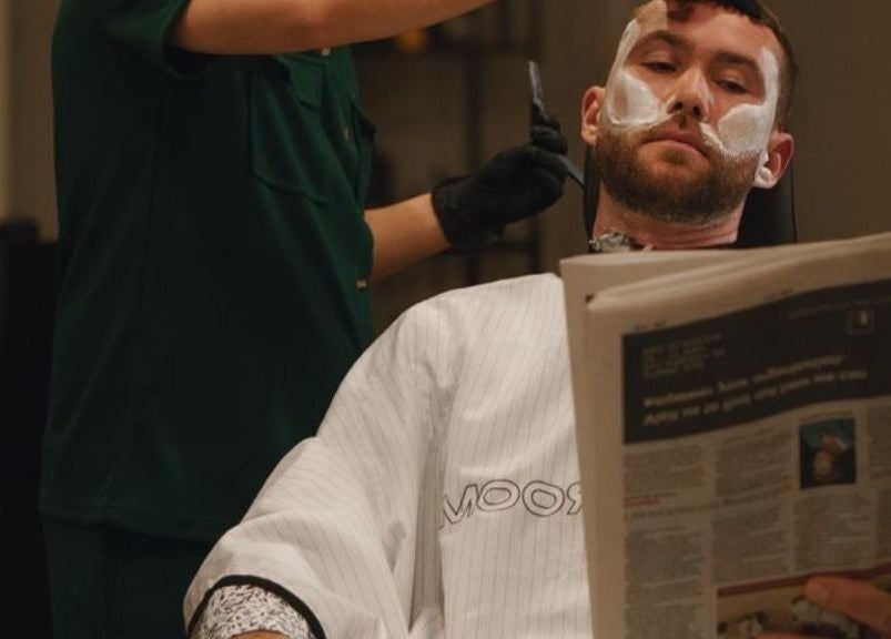 A client receiving a shave at His Grooming in Ayr, Scotland, GB, showcasing luxury grooming services.