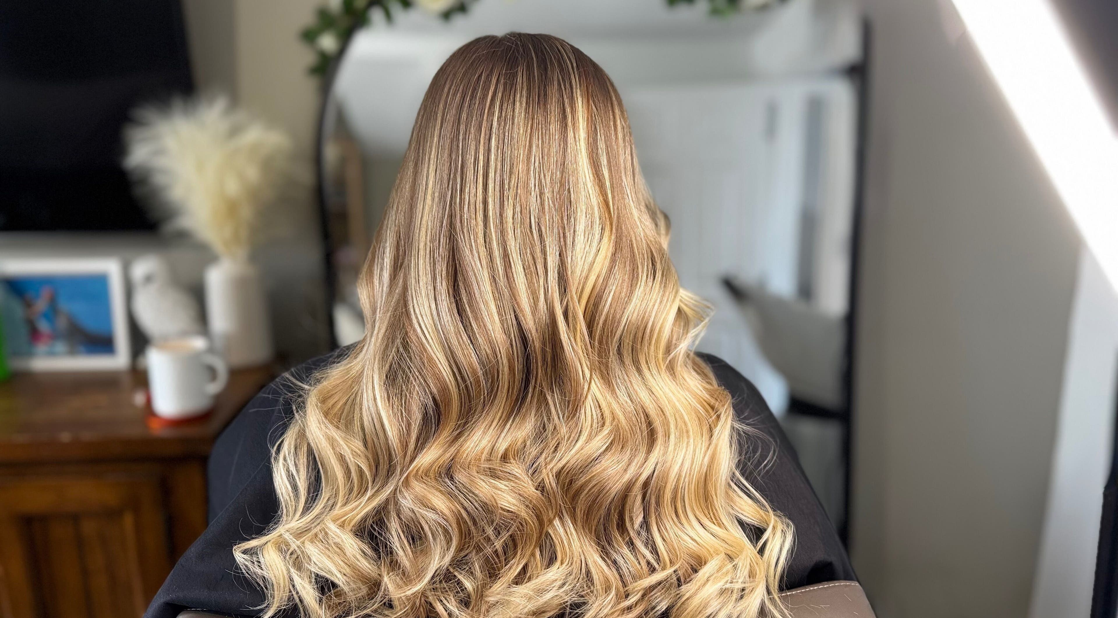 Gorgeous wavy blonde hair at Luxe Locks, York, England, GB, showcasing expert styling.