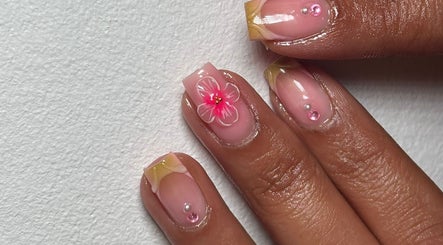 Elegant floral nail design at CMS NAILS, London, England, GB with pink gems and delicate flower motifs.
