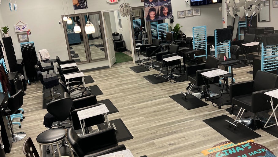 Modern salon interior at Gina African Hair Braiding, Cincinnati, Ohio, US, showcasing stylish seating and decor.