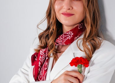 Woman in white blazer with red scarf at MaryAest, Kelowna, British Columbia, CA.