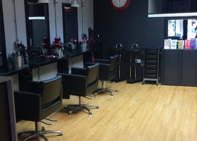 Sleek Vibe. Hair by Sharon salon interior in Kidderminster, England, showcasing styling stations and chairs.