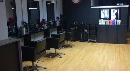 Sleek Vibe. Hair by Sharon salon interior in Kidderminster, England, showcasing styling stations and chairs.
