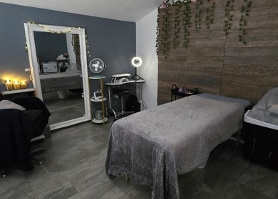 Relaxing spa room at Loveli, Grangemouth, Scotland, GB with cozy massage table and serene decor.