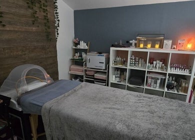 Relaxing spa room at Loveli in Grangemouth, Scotland, GB with cozy treatment bed and soothing decor.