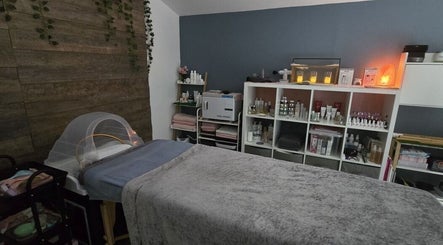 Relaxing spa room at Loveli in Grangemouth, Scotland, GB with cozy treatment bed and soothing decor.