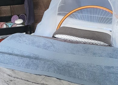 Cozy beauty treatment station at Loveli, Grangemouth, Scotland, GB, featuring a massage bed and spa tools.