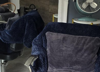 Plush chair in Loveli salon, Grangemouth, Scotland, GB offering a relaxing beauty experience.