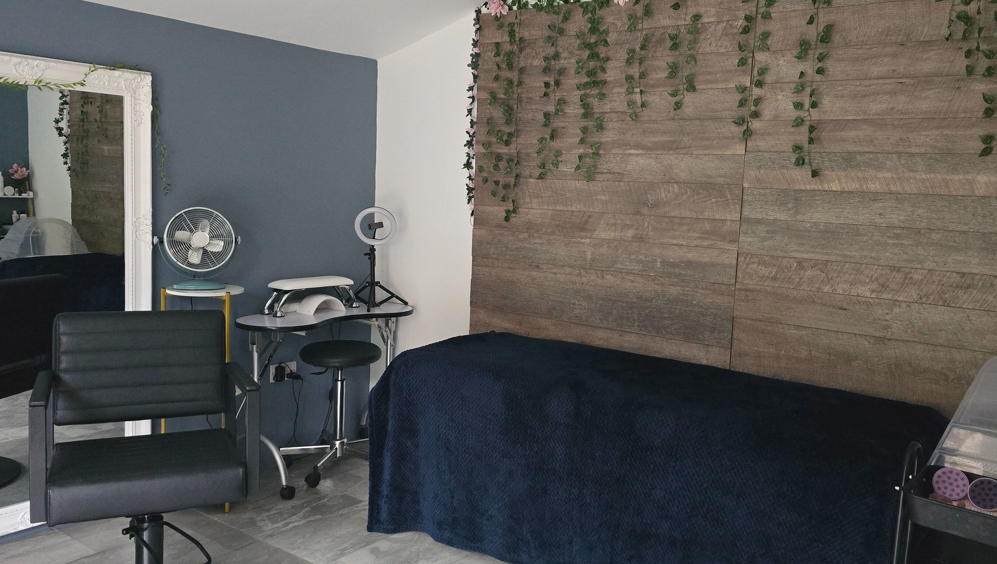 Modern beauty room at Loveli, Grangemouth, Scotland, GB, featuring sleek chair and rustic decor.