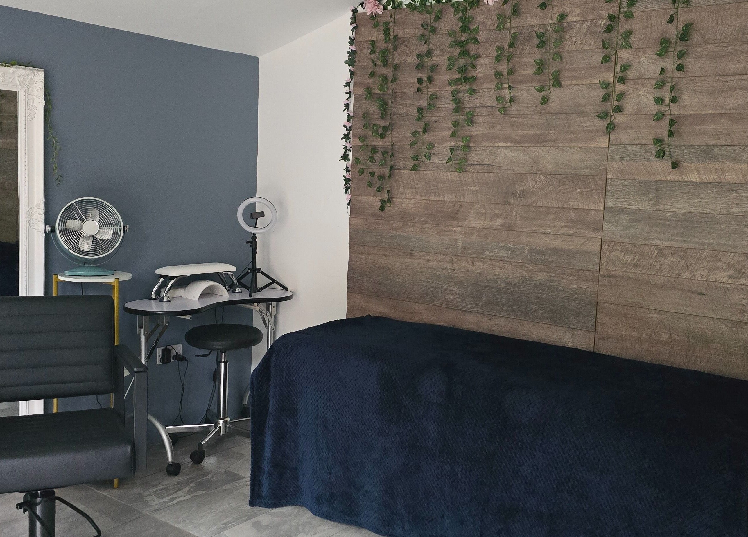 Modern beauty room at Loveli, Grangemouth, Scotland, GB, featuring sleek chair and rustic decor.