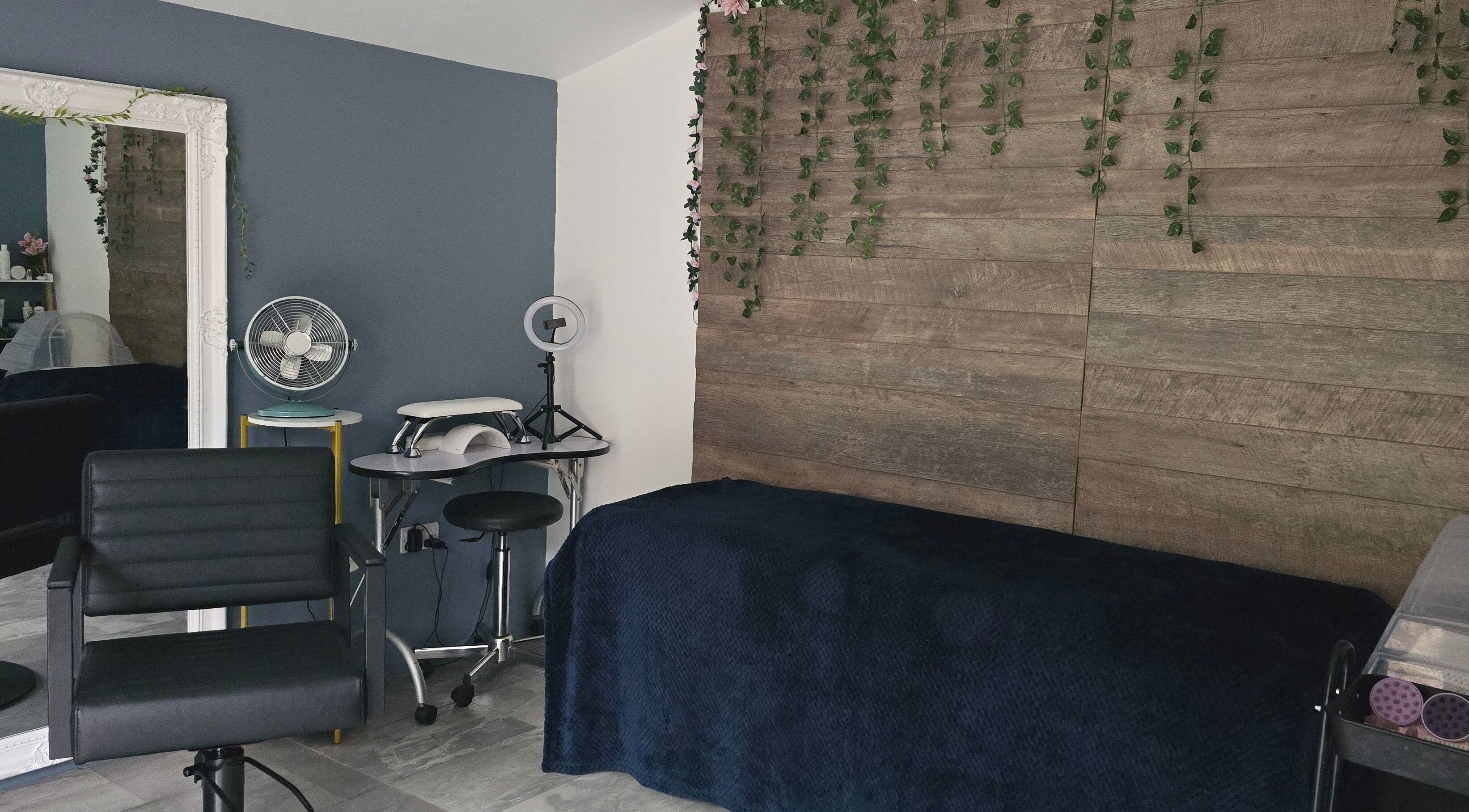 Modern beauty room at Loveli, Grangemouth, Scotland, GB, featuring sleek chair and rustic decor.