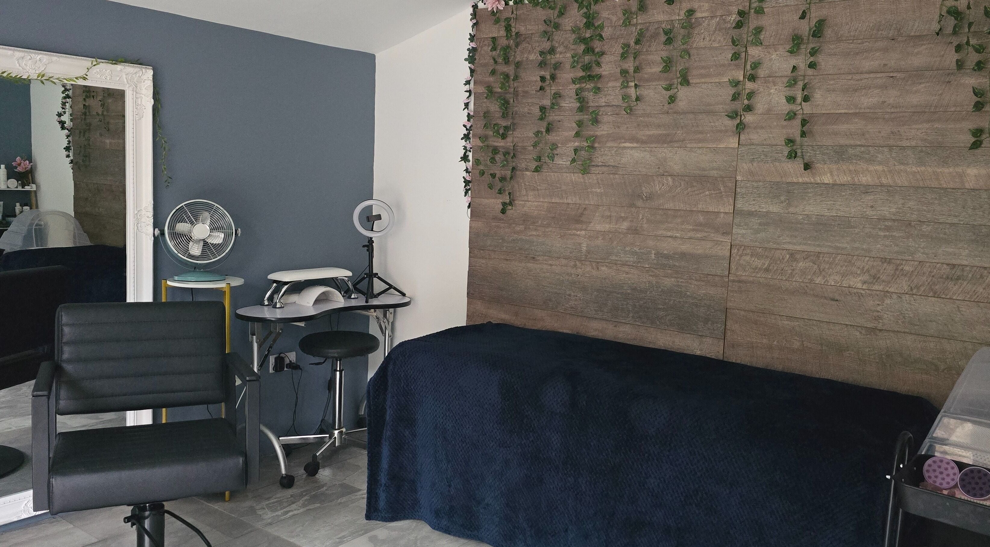 Modern beauty room at Loveli, Grangemouth, Scotland, GB, featuring sleek chair and rustic decor.
