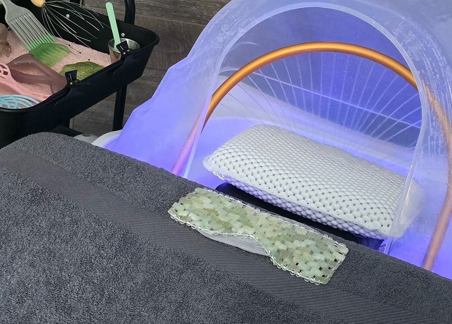 Relaxing treatment setup at Loveli in Grangemouth, Scotland, GB showcasing a massage bed and spa tools.