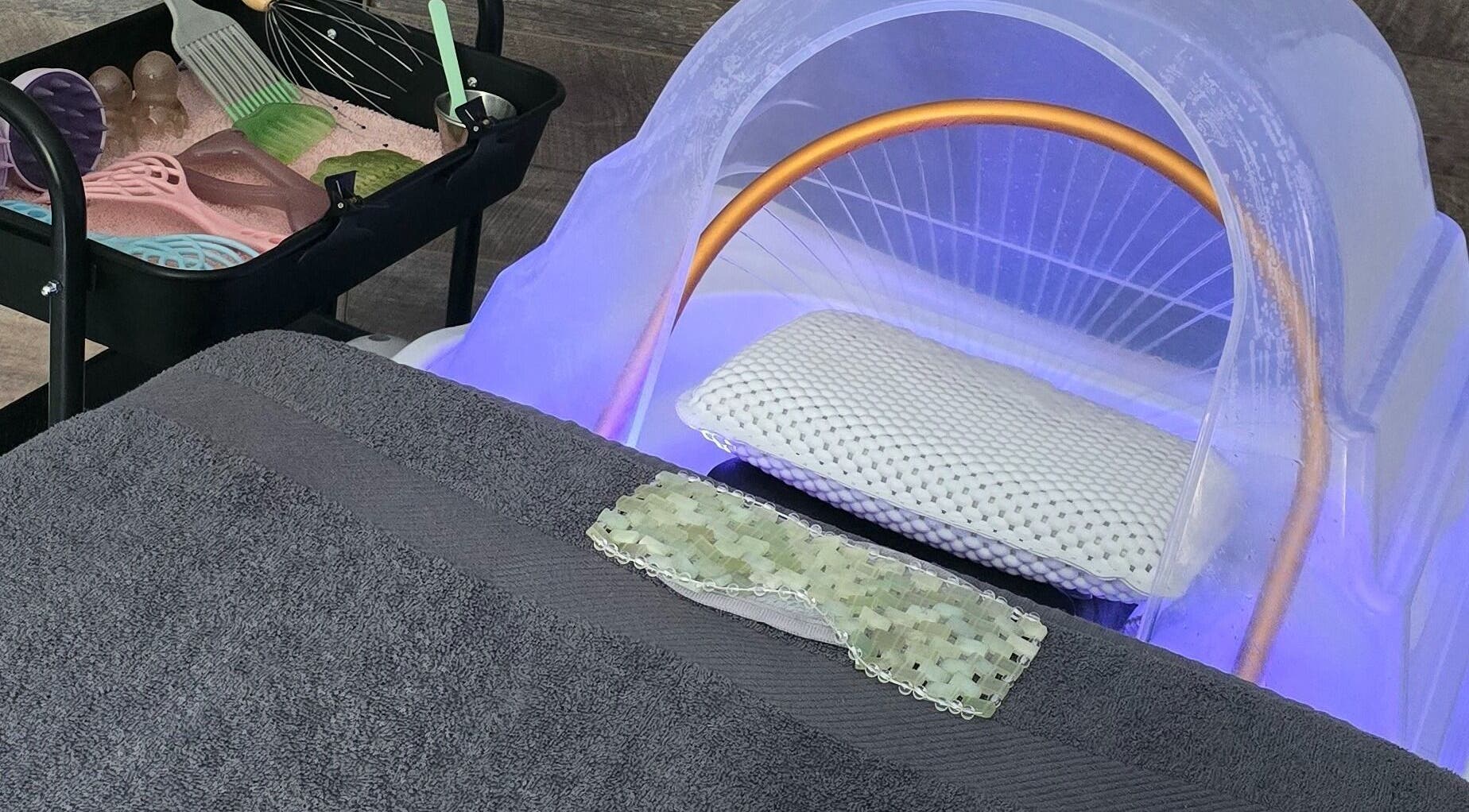 Relaxing treatment setup at Loveli in Grangemouth, Scotland, GB showcasing a massage bed and spa tools.