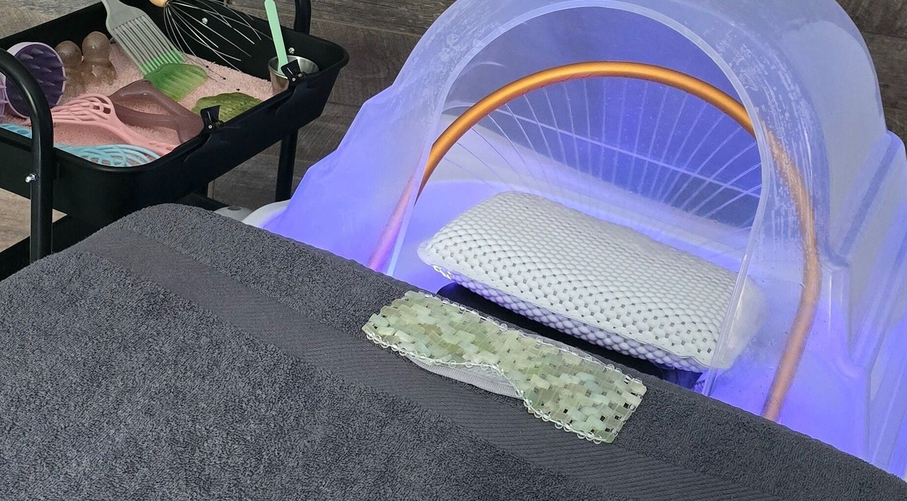 Relaxing treatment setup at Loveli in Grangemouth, Scotland, GB showcasing a massage bed and spa tools.