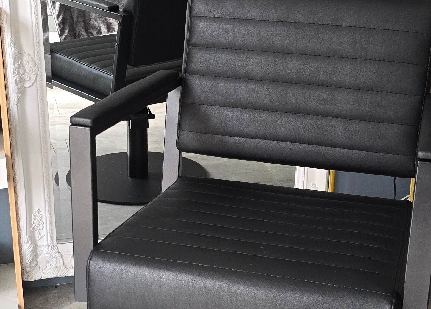 Modern salon chair at Loveli, Grangemouth, Scotland, GB, reflecting sleek design and comfort.