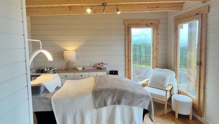 Cozy wellness room at By Lana Grace, Ludgvan, England, GB, featuring a treatment bed and serene decor.