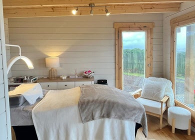 Cozy wellness room at By Lana Grace, Ludgvan, England, GB, featuring a treatment bed and serene decor.