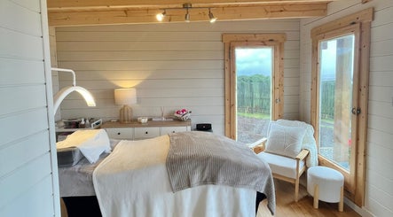 Cozy wellness room at By Lana Grace, Ludgvan, England, GB, featuring a treatment bed and serene decor.