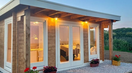 Warmly lit beauty cabin at By Lana Grace in Ludgvan, England, GB, enhancing a serene wellness ambiance.