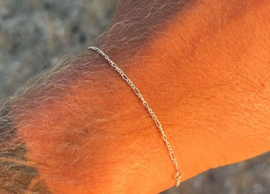 Elegant silver bracelet on wrist at By Lana Grace, Ludgvan, England, GB. Captured in natural sunlight.