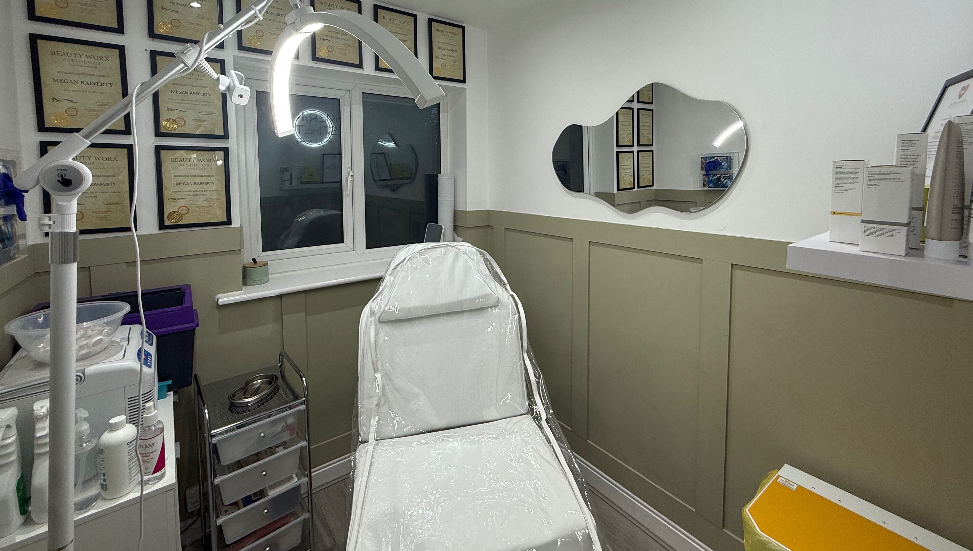 Well-equipped treatment room at Meraki Aesthetics, Eccles, England, GB showcasing beauty certificates and modern design.